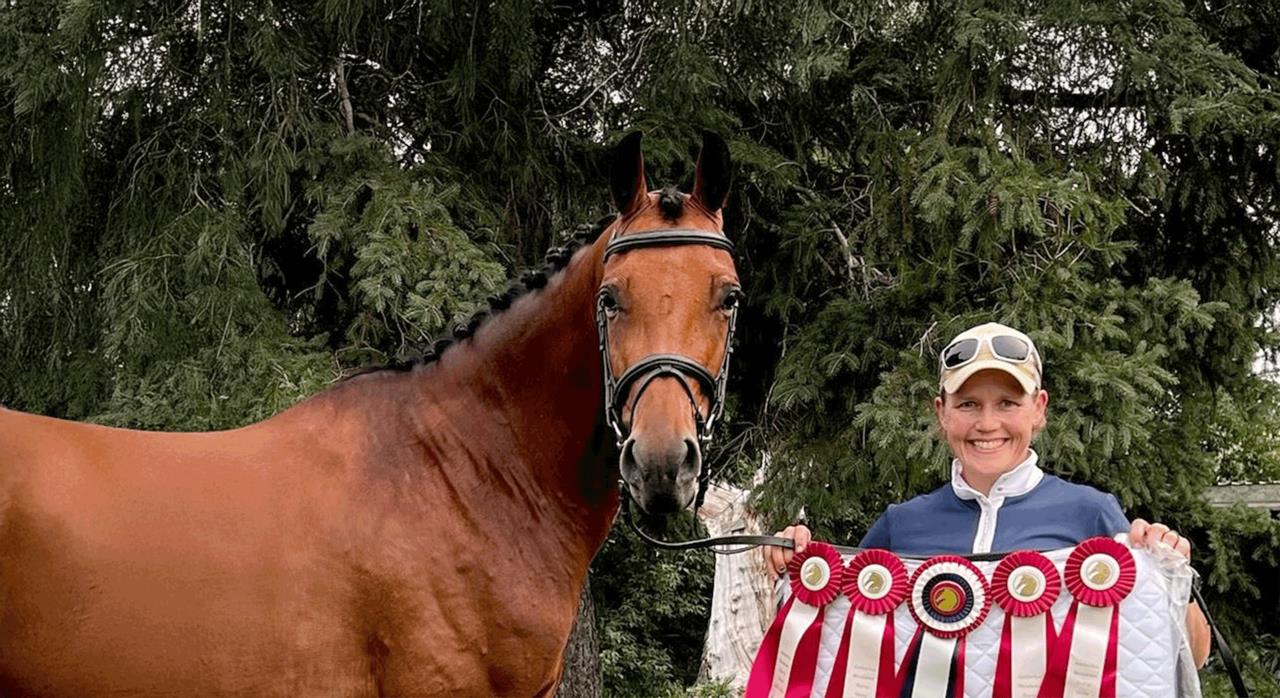 Distinguished mare standing beside a rider holding medals, symbolizing a successful competitive equestrian history.
